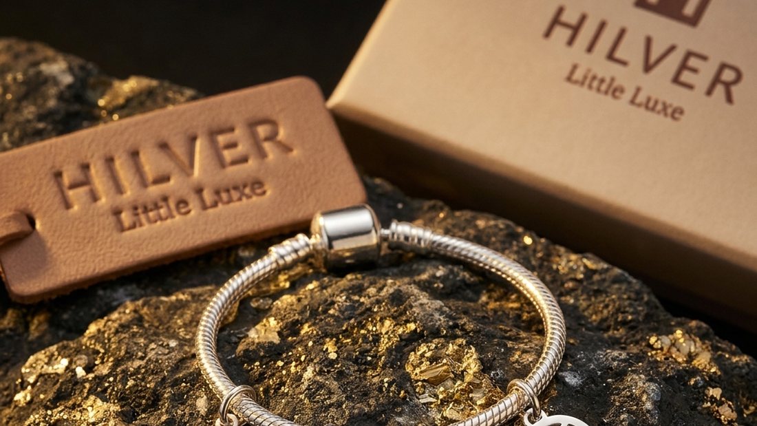 A Hilver charm bracelet on display beside its branded box and leather price tag